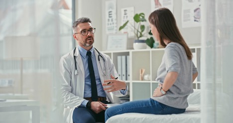 A woman is having a consultation with her doctor for her treatment; doctor explaining the difference between BS vs celiac disease